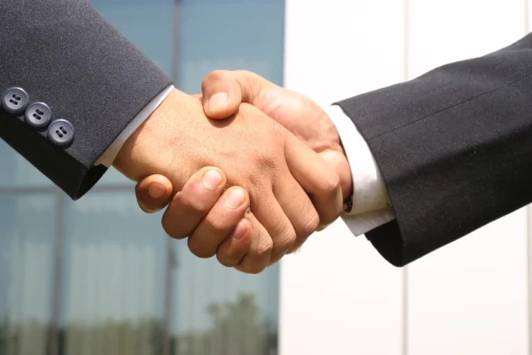 an image of two individual shaking hands.